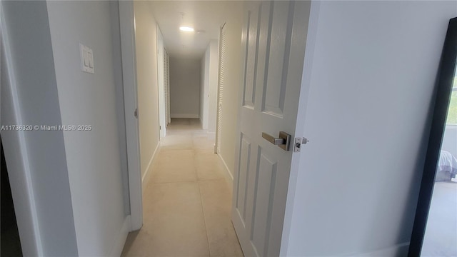 hall featuring light tile patterned floors