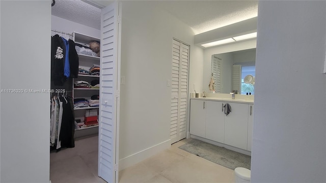 bathroom with vanity and a textured ceiling