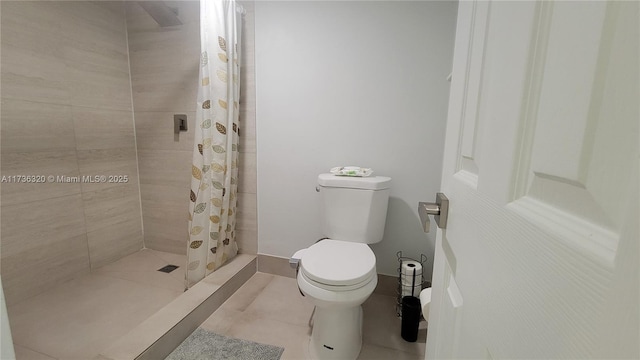 bathroom with a shower with curtain, toilet, and tile patterned flooring