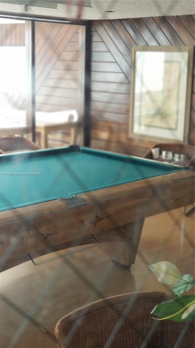 rec room featuring billiards and wooden walls