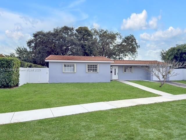 ranch-style house with a front lawn