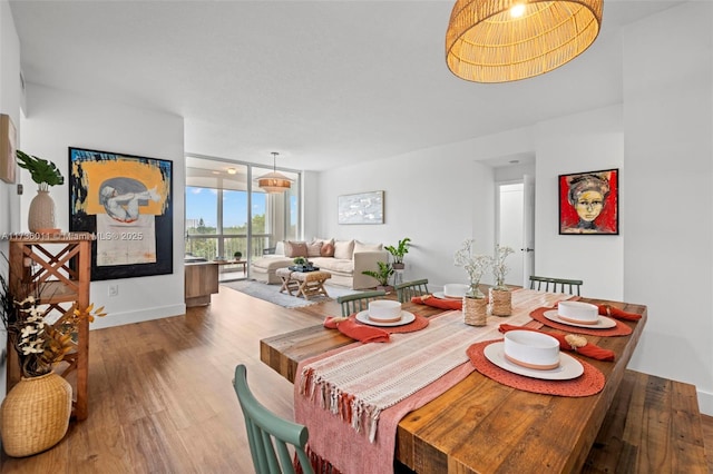 dining space featuring hardwood / wood-style flooring and floor to ceiling windows