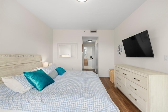 bedroom featuring dark hardwood / wood-style flooring