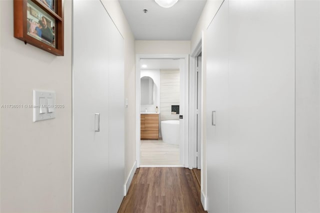 corridor featuring wood-type flooring