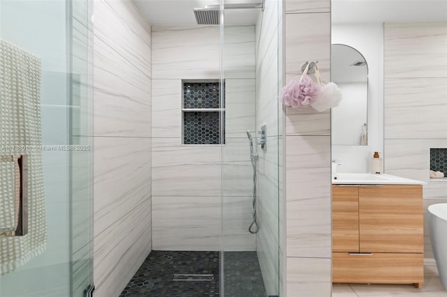 bathroom featuring vanity and separate shower and tub