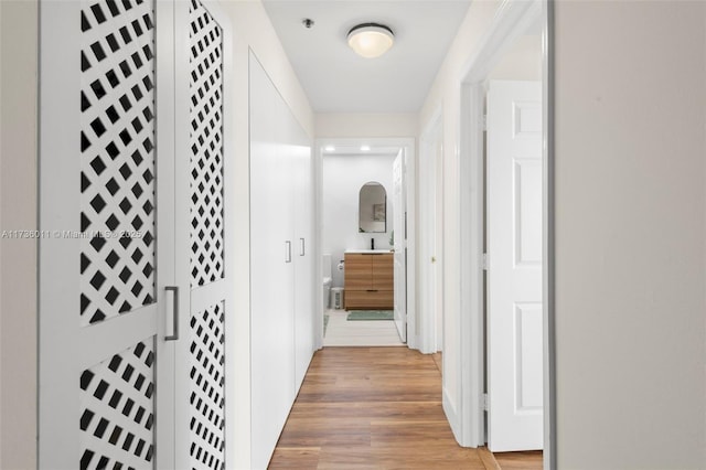 hallway with light hardwood / wood-style flooring