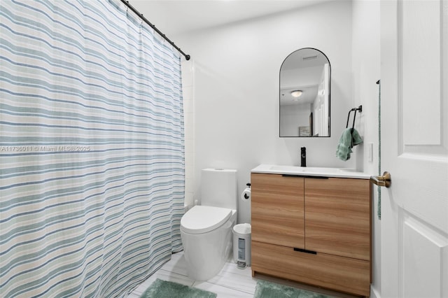 bathroom featuring vanity, toilet, and walk in shower