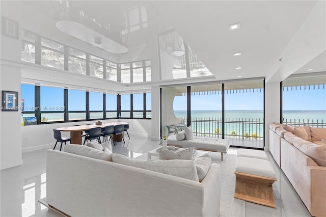 living room featuring floor to ceiling windows and a water view