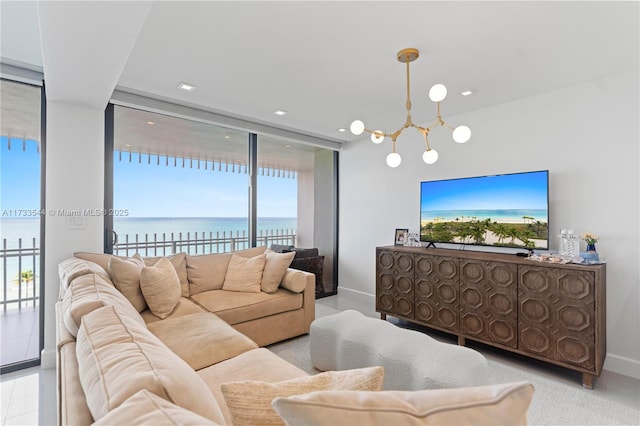 living room featuring a water view, floor to ceiling windows, and a notable chandelier