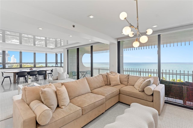 living room featuring a water view, an inviting chandelier, and a wealth of natural light