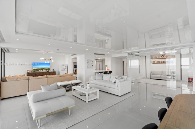 living room with an inviting chandelier, light tile patterned flooring, and a high ceiling