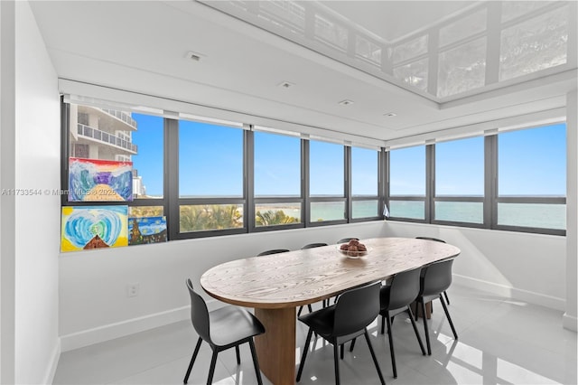 dining room featuring a water view