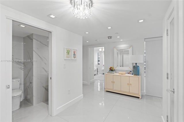 bathroom featuring vanity, toilet, and an inviting chandelier