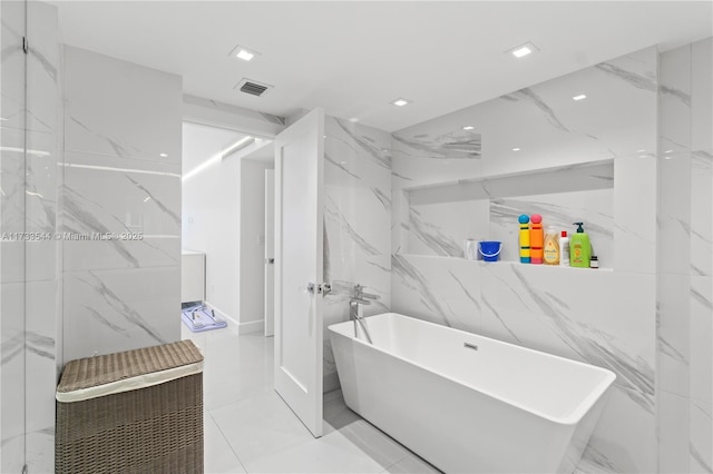 bathroom featuring tile walls and a tub