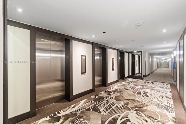 hallway with carpet floors and elevator