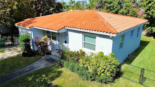 mediterranean / spanish home featuring a front lawn