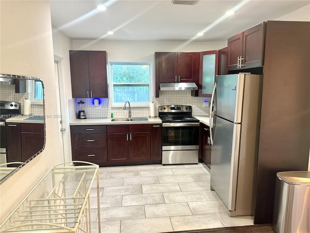 kitchen with stainless steel appliances, tasteful backsplash, and sink