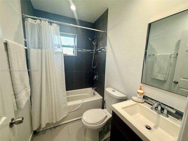 full bathroom featuring shower / bathtub combination with curtain, vanity, tile patterned floors, and toilet