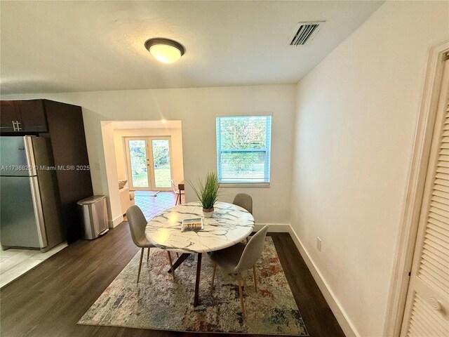 dining room featuring dark hardwood / wood-style flooring and french doors