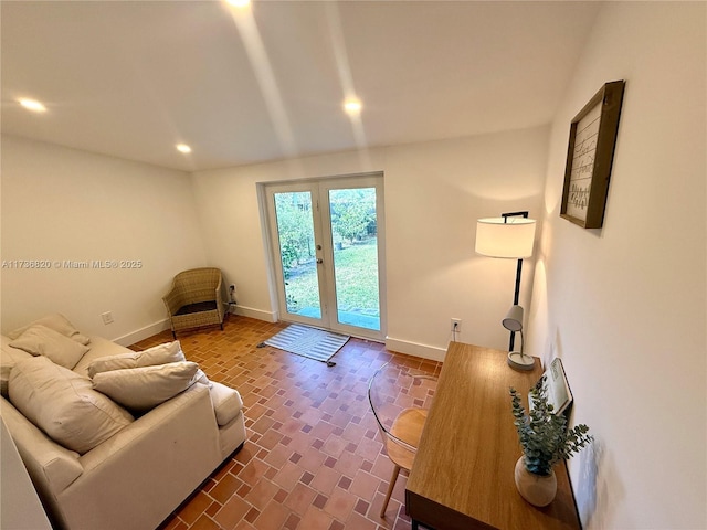 living area with brick floor, recessed lighting, and baseboards