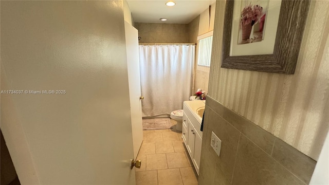 bathroom with tile patterned flooring, vanity, a shower with shower curtain, and toilet