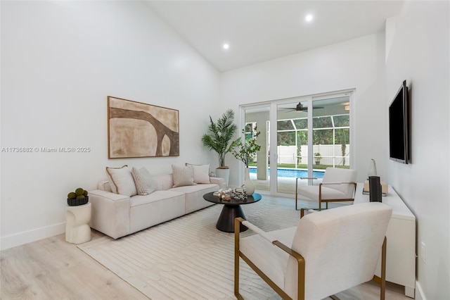 living room with ceiling fan and light hardwood / wood-style floors