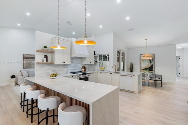 kitchen featuring white appliances, a peninsula, custom exhaust hood, and open shelves