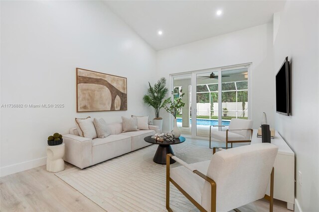 living room featuring ceiling fan and light hardwood / wood-style floors