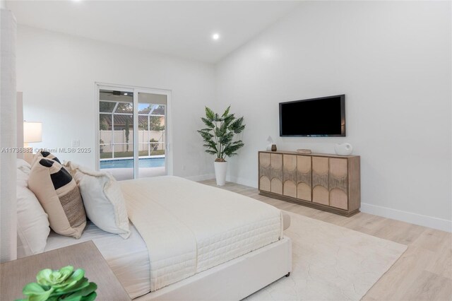 bedroom featuring access to exterior and light hardwood / wood-style flooring