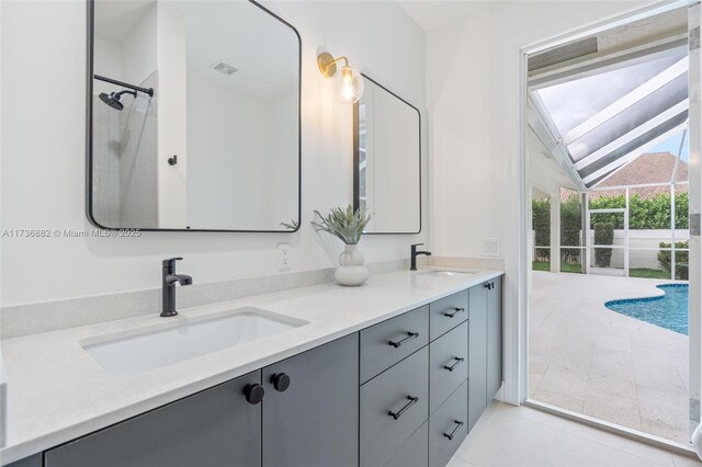 bathroom with lofted ceiling, vanity, and a shower