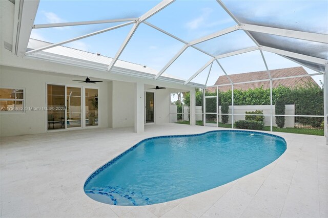 view of pool featuring a patio area, ceiling fan, and glass enclosure