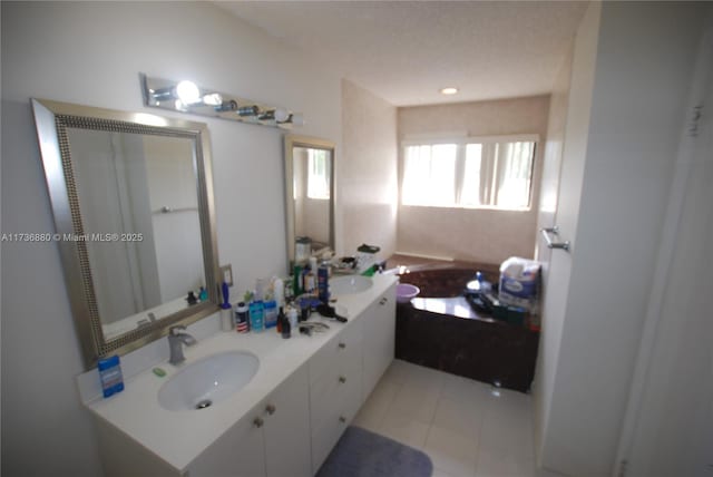 bathroom featuring vanity, tile patterned flooring, and a bathing tub