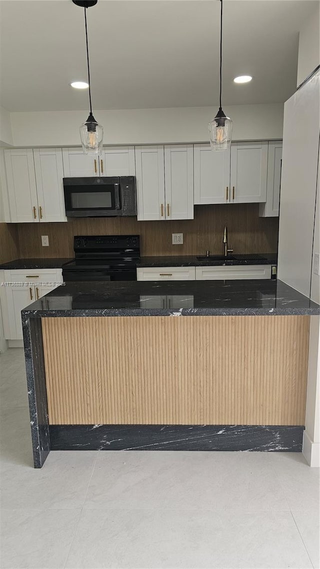 kitchen featuring white cabinetry, decorative light fixtures, and black appliances