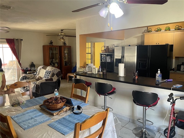 dining area featuring ceiling fan and light tile patterned floors