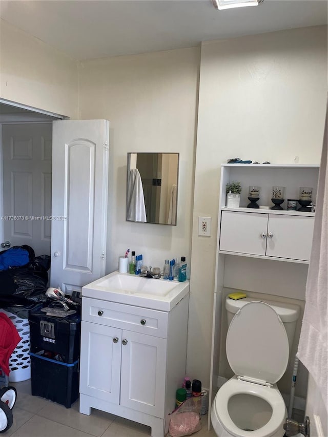 bathroom with vanity, tile patterned floors, and toilet