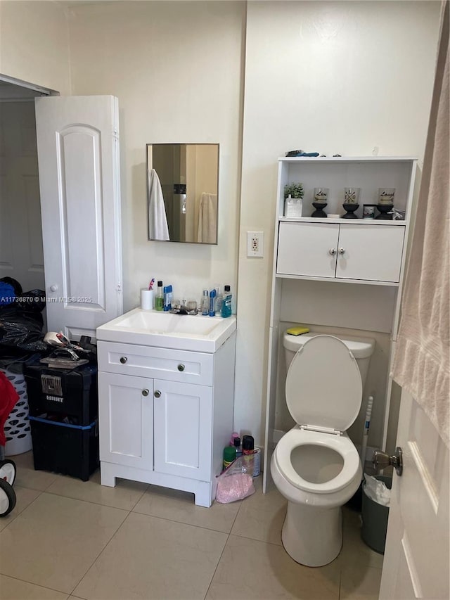 bathroom featuring vanity, toilet, and tile patterned flooring