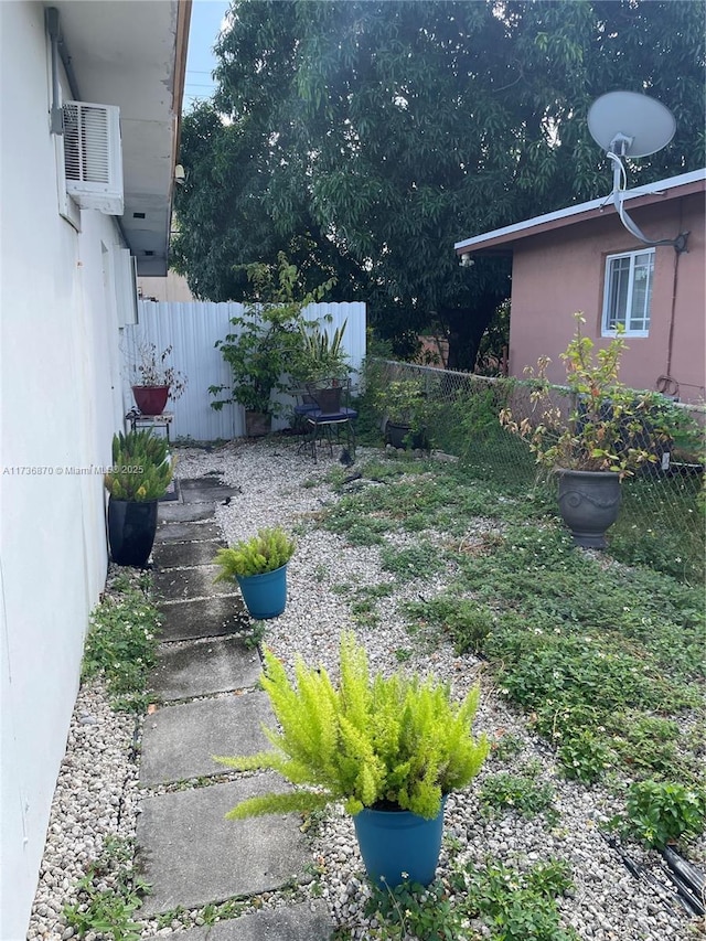 view of yard with a wall mounted air conditioner