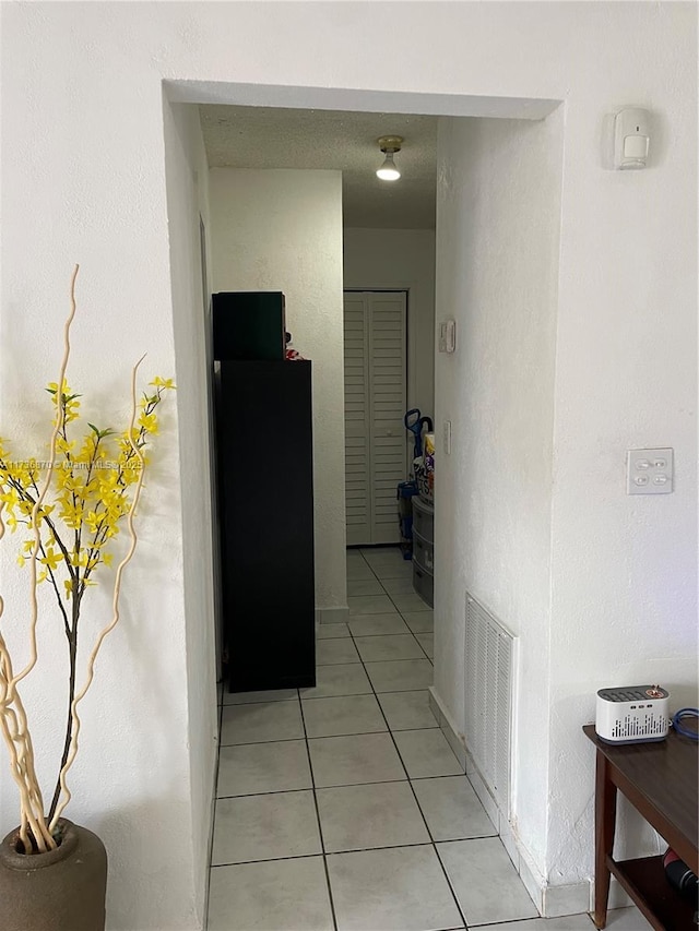 hallway with light tile patterned flooring