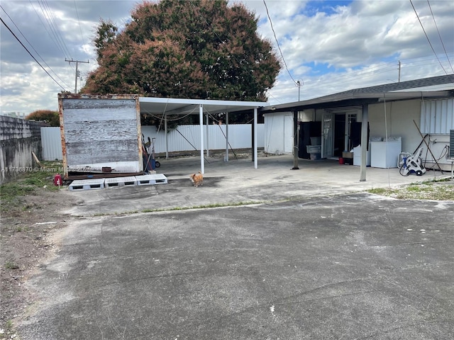 view of vehicle parking featuring independent washer and dryer