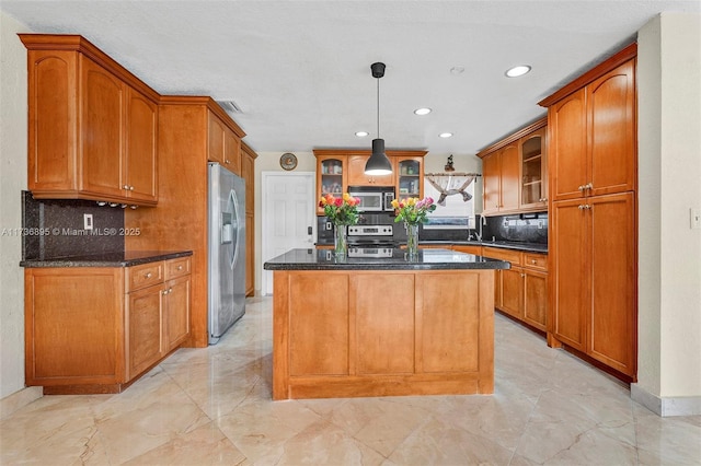 15750 SW 232nd St, Miami, FL 33170 - kitchen featuring appliances with stainless steel finishes, recessed lighting, backsplash, glass insert cabinets, and a center island