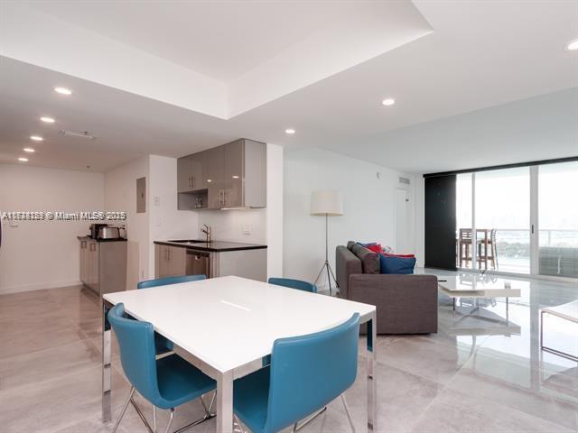 dining area featuring sink and a wall of windows