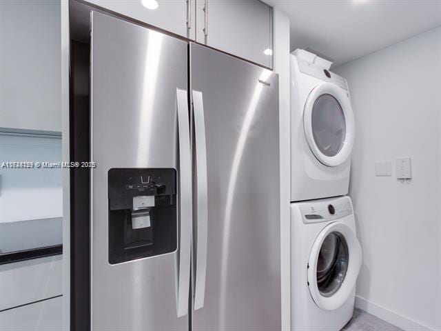 clothes washing area featuring stacked washer and dryer