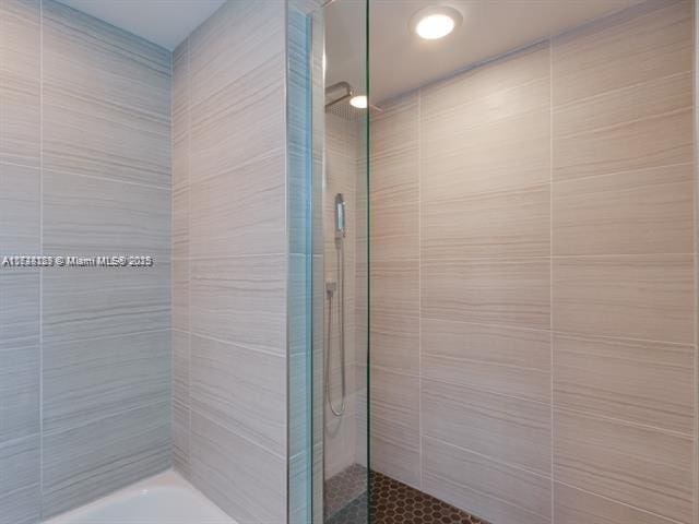 bathroom with tiled shower