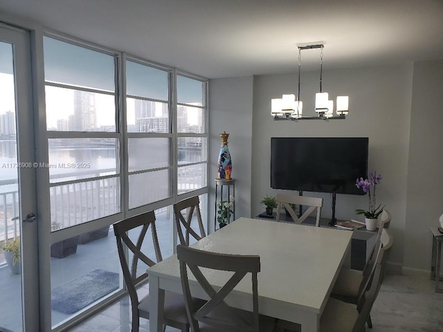 dining area featuring expansive windows and a chandelier