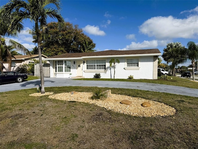 ranch-style home featuring a front yard