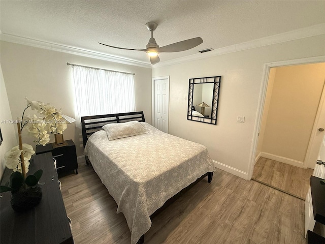 bedroom with dark hardwood / wood-style flooring, ornamental molding, a closet, and a textured ceiling