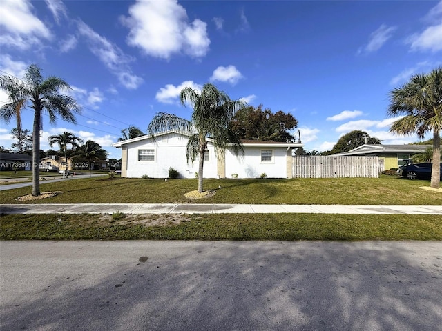 ranch-style home with a front lawn