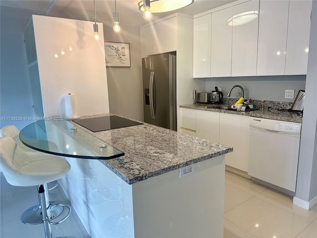 kitchen with black electric stovetop, white cabinets, dishwasher, and stainless steel refrigerator with ice dispenser