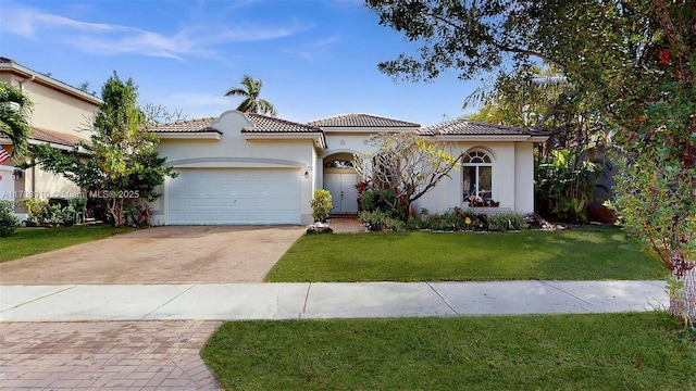 mediterranean / spanish-style home with a garage and a front lawn