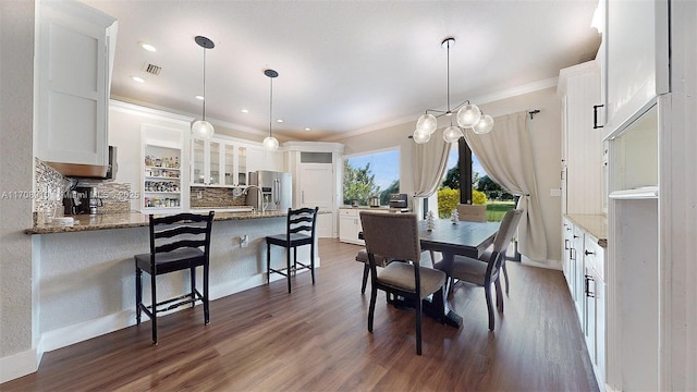 dining space featuring crown molding and dark hardwood / wood-style floors